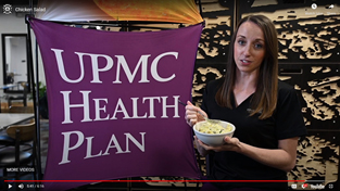 woman next to UPMC Health Plan sign